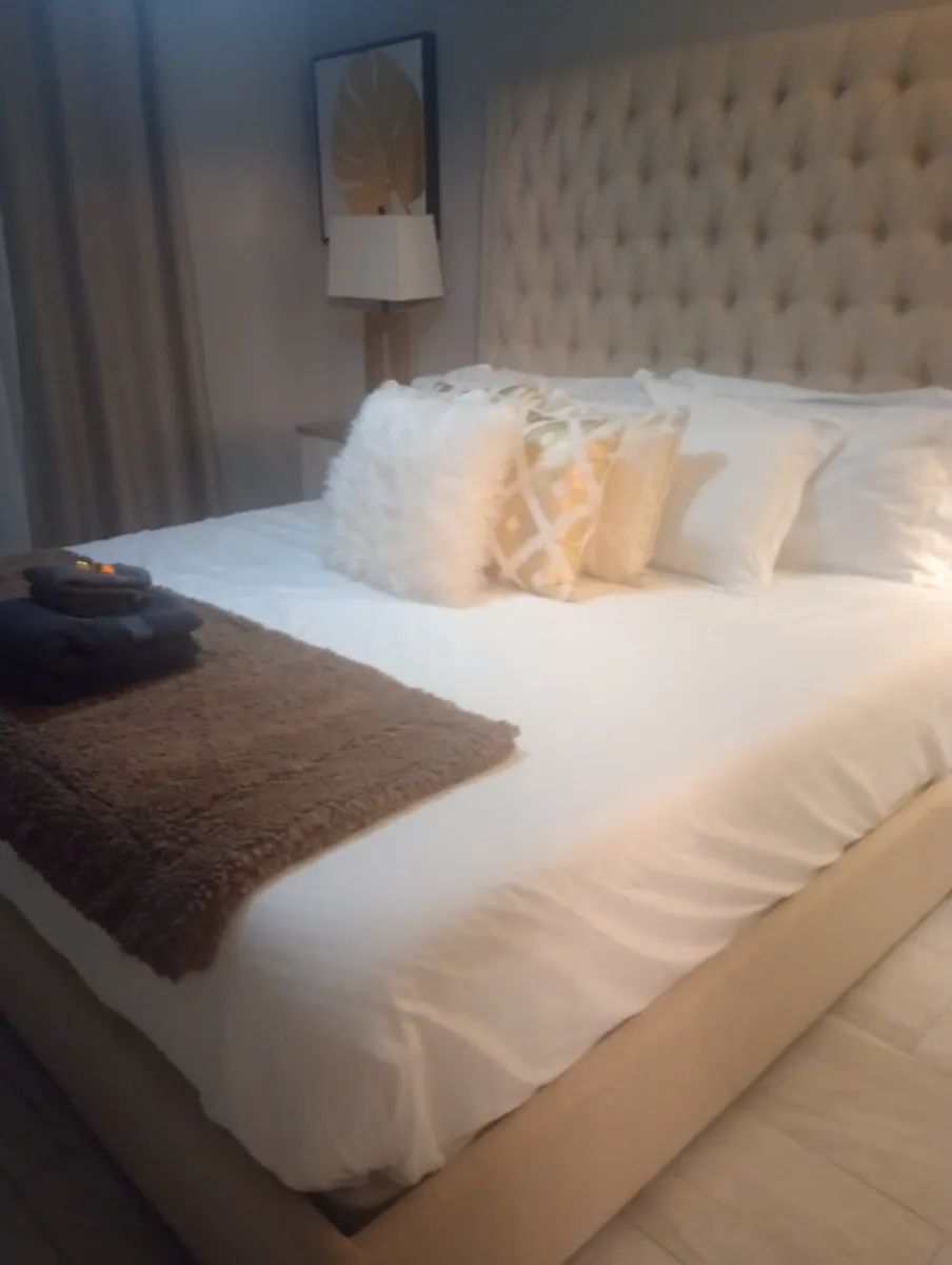 Guest bed made crisp and hotel-ready, cleaned by Tidy Up Solutions Cleaning Services in the Phoenix area