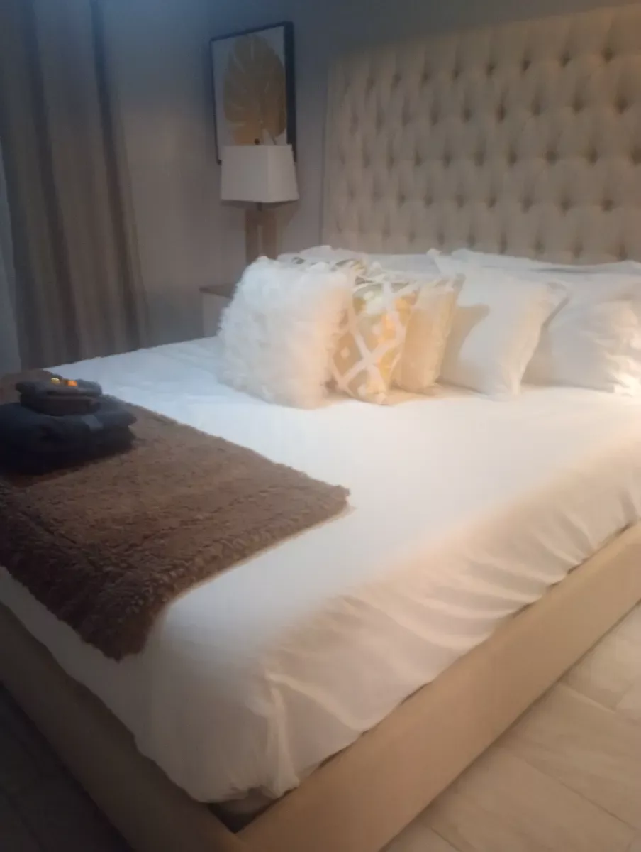 Guest bed made crisp and hotel-ready, cleaned by Tidy Up Solutions Cleaning Services in the Phoenix area
