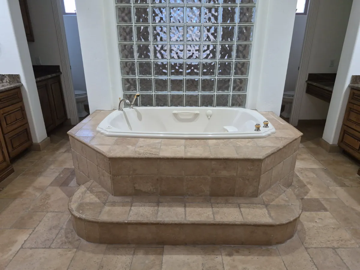 Jetted tub and travertine surround, soap scum gone, cleaned by Tidy Up Solutions Cleaning Services in the Phoenix area