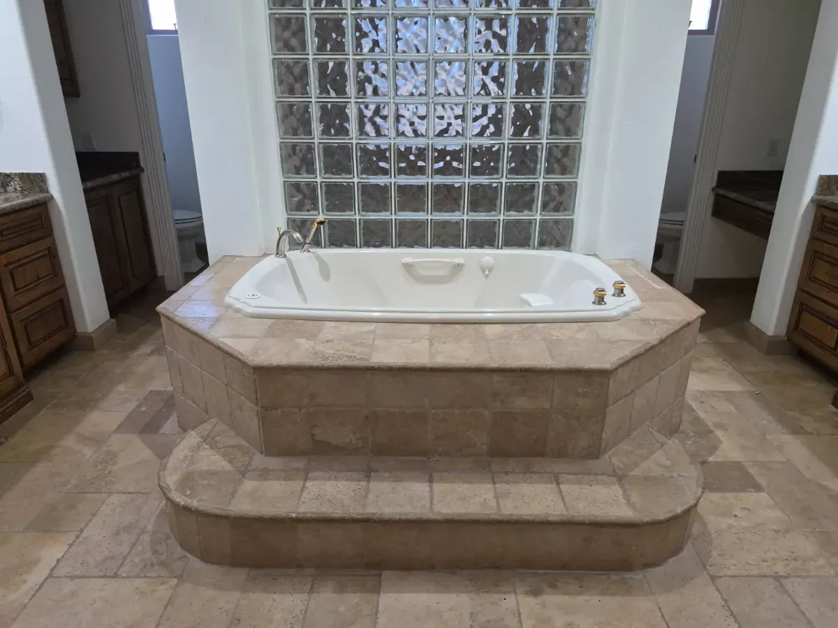 Jetted tub and travertine surround, soap scum gone, cleaned by Tidy Up Solutions Cleaning Services in the Phoenix area