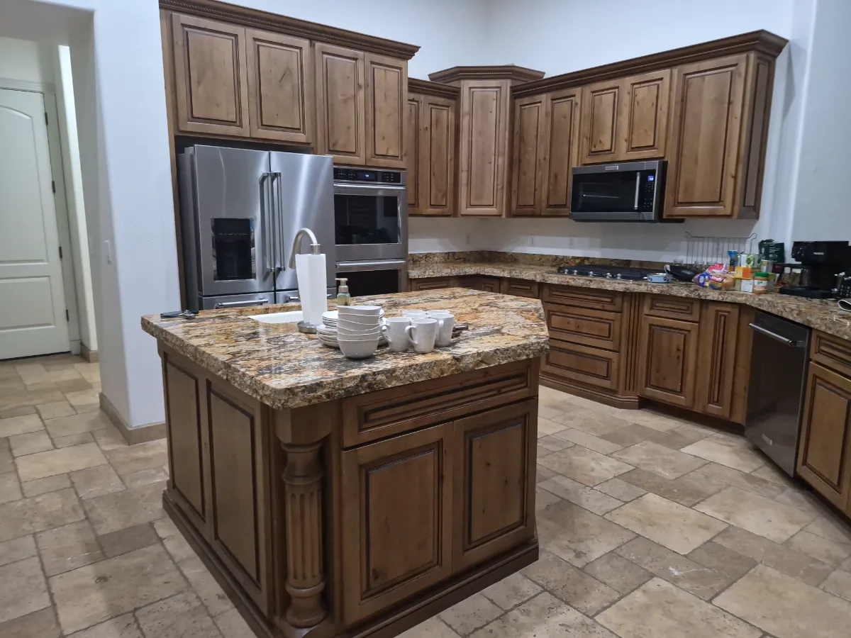 Granite island, cabinets and appliances, wiped and shining, cleaned by Tidy Up Solutions Cleaning Services in the Phoenix area