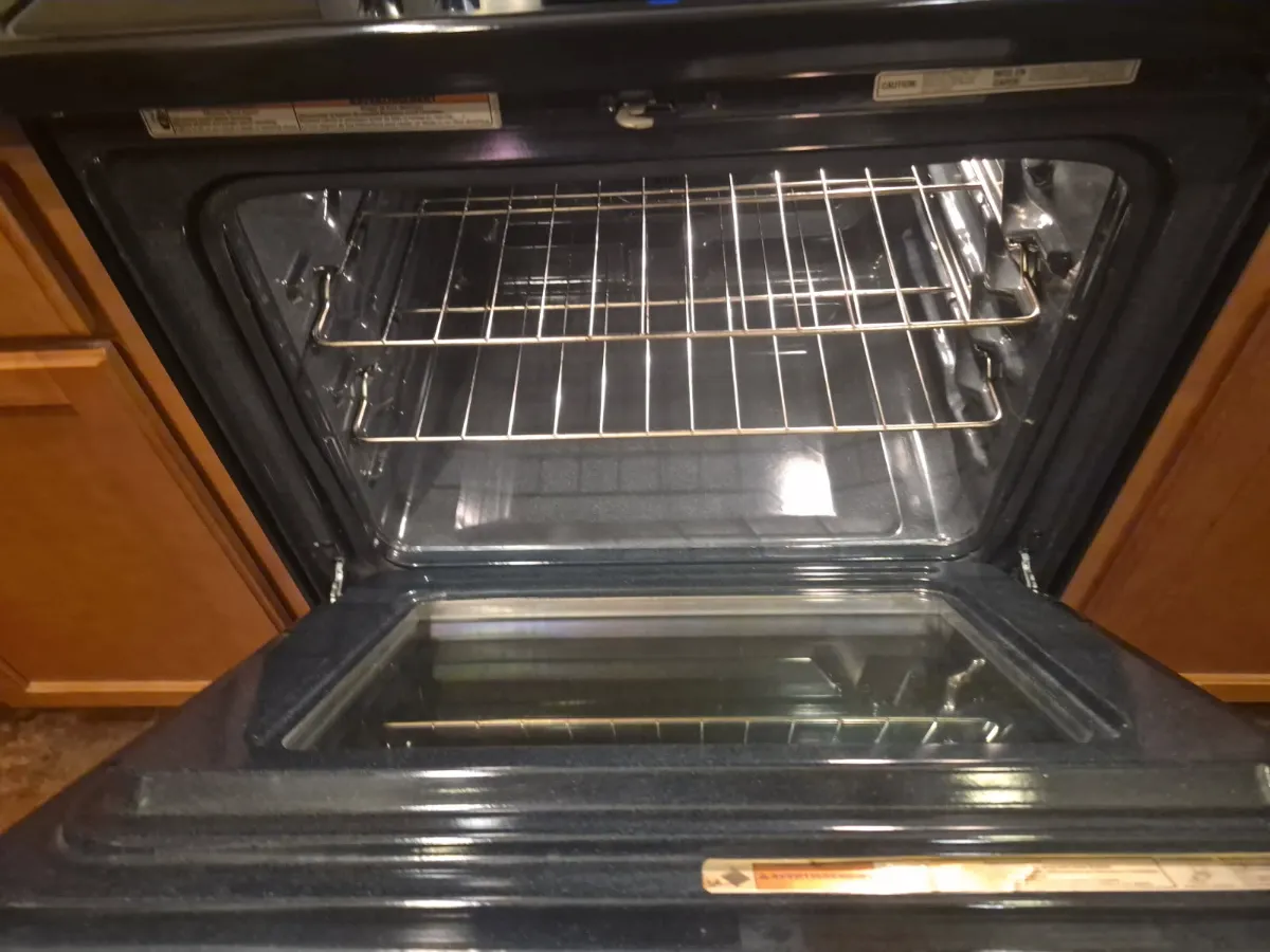 Oven interior scrubbed free of grease and buildup, cleaned by Tidy Up Solutions Cleaning Services in the Phoenix area